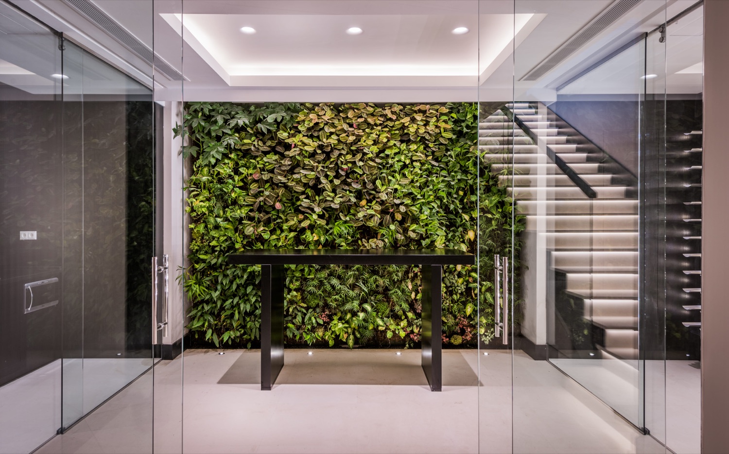 Puertas de vidrio y escalera con cerramiento de cristal en villa de Marbella